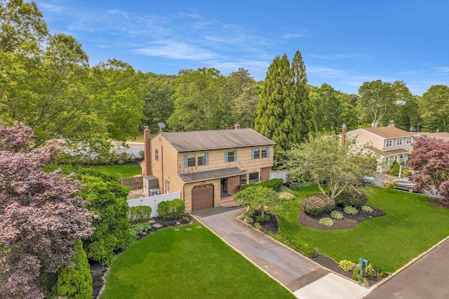 8 Astro Ct, Holtsville, NY 11742 - view of front facade with a garage, concrete driveway, brick siding, a chimney, and a wooded view
