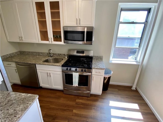 90 Bryant Ave Unit 5B-E, White Plains, NY 10605 - kitchen featuring stainless steel appliances, a sink, white cabinets, and plenty of natural light