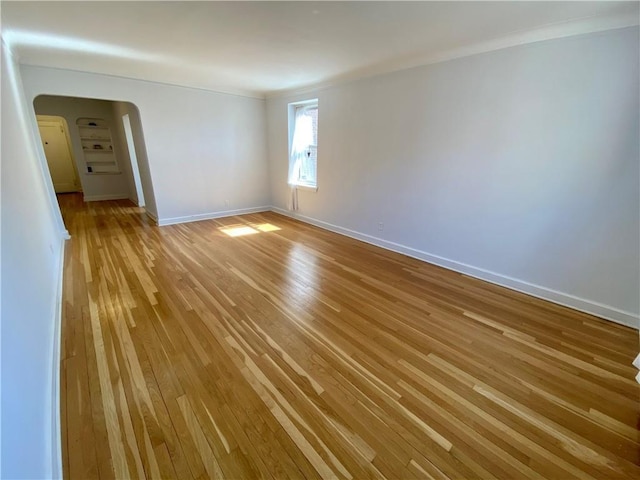 90 Bryant Ave Unit 5B-E, White Plains, NY 10605 - unfurnished room with light wood finished floors, arched walkways, baseboards, and ornamental molding