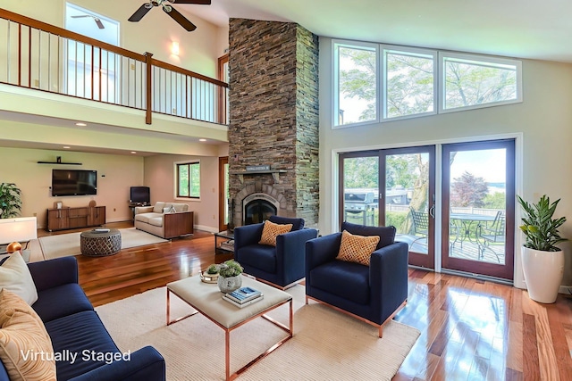 6 Riverside, Cornwall On Hudson, NY 12520 - living room featuring a towering ceiling, ceiling fan, hardwood / wood-style flooring, and a stone fireplace