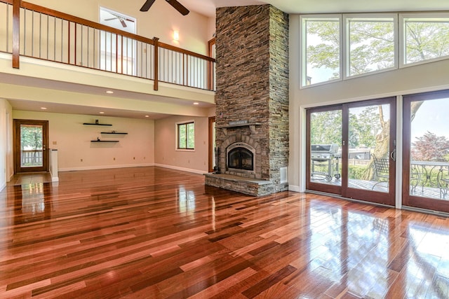 6 Riverside, Cornwall On Hudson, NY 12520 - unfurnished living room with a ceiling fan, a towering ceiling, plenty of natural light, wood finished floors, and a fireplace
