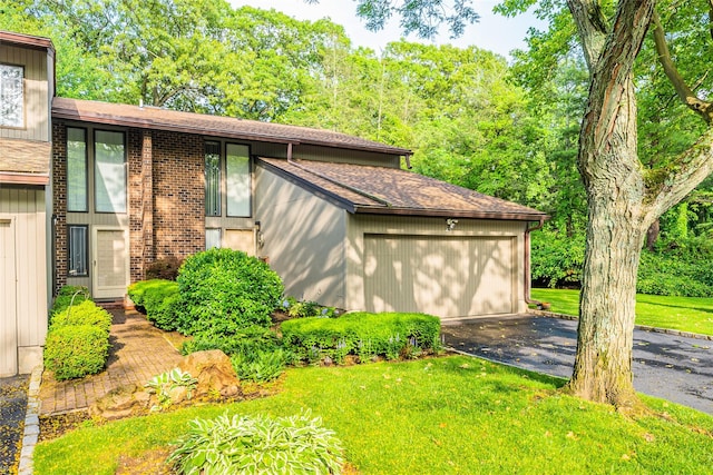 43 Carriage Ct, Jericho, NY 11753 - view of front of home featuring asphalt driveway, a shingled roof, and a front lawn