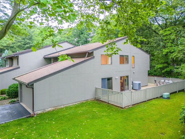 43 Carriage Ct, Jericho, NY 11753 - back of property featuring central AC, a lawn, and a deck