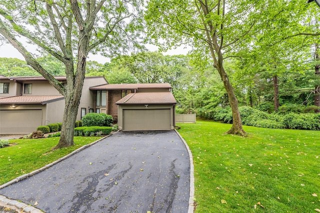 43 Carriage Ct, Jericho, NY 11753 - view of front of home featuring asphalt driveway, a front lawn, and a garage