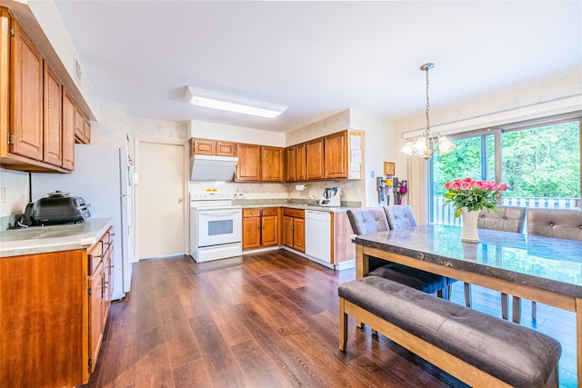 43 Carriage Ct, Jericho, NY 11753 - kitchen with white appliances, dark wood-style floors, brown cabinets, light countertops, and a chandelier