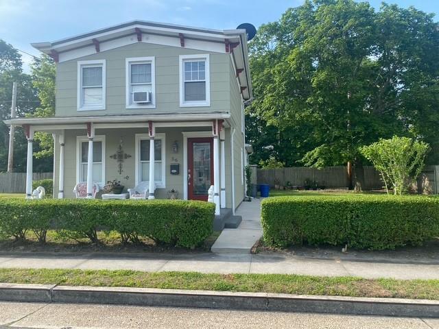 56 Academy St, Patchogue, NY 11772 - italianate-style house with covered porch and cooling unit