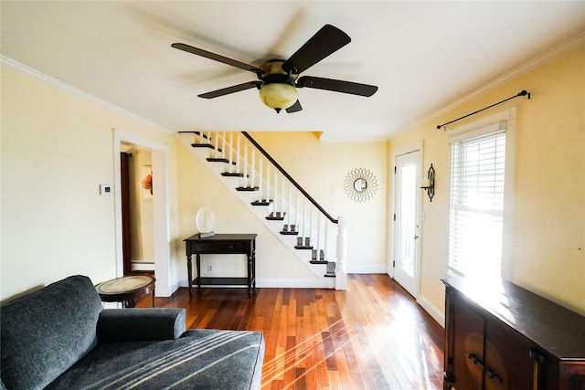 56 Academy St, Patchogue, NY 11772 - entryway with wood-type flooring, stairway, a baseboard radiator, a ceiling fan, and crown molding