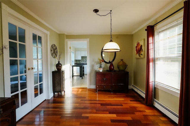 56 Academy St, Patchogue, NY 11772 - dining space with french doors, a baseboard heating unit, wood finished floors, and ornamental molding