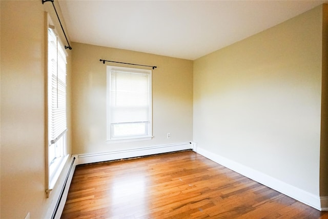 56 Academy St, Patchogue, NY 11772 - unfurnished room featuring wood finished floors, a baseboard radiator, and a baseboard heating unit