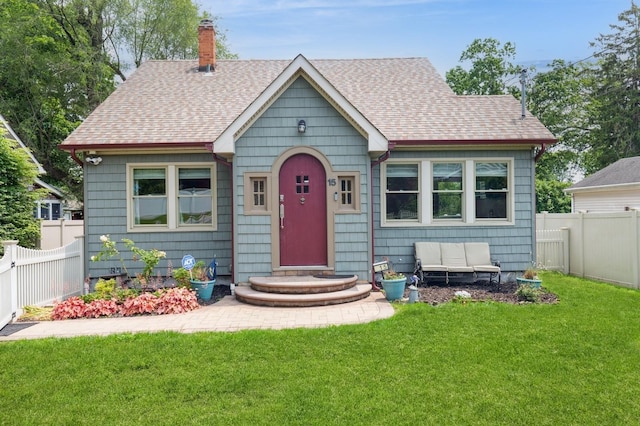 15 Orchard Rd, East Patchogue, NY 11772 - view of front of property with a chimney, a shingled roof, and a fenced backyard