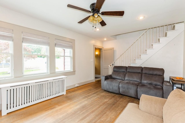 15 Orchard Rd, East Patchogue, NY 11772 - living room with radiator, light wood finished floors, stairway, ceiling fan, and recessed lighting