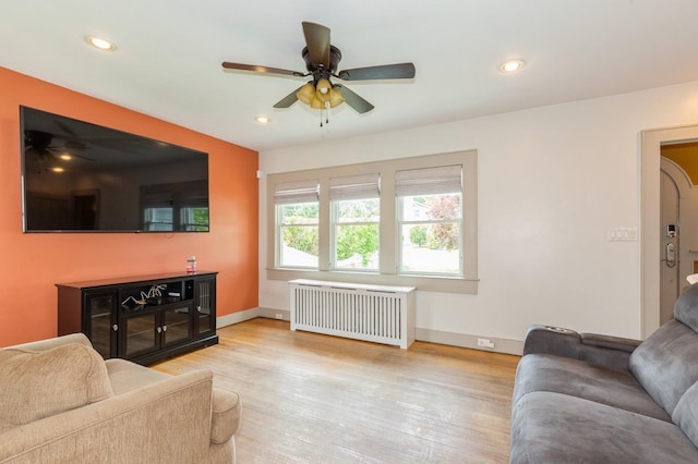 15 Orchard Rd, East Patchogue, NY 11772 - living area with radiator heating unit, a ceiling fan, wood finished floors, and recessed lighting