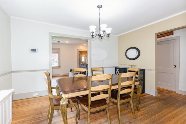 15 Orchard Rd, East Patchogue, NY 11772 - dining area with ornamental molding, wood finished floors, and a chandelier