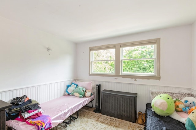 15 Orchard Rd, East Patchogue, NY 11772 - bedroom with multiple windows, radiator heating unit, and wainscoting