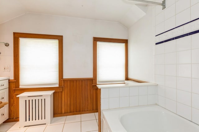 15 Orchard Rd, East Patchogue, NY 11772 - full bathroom with lofted ceiling, plenty of natural light, a garden tub, vanity, and wainscoting