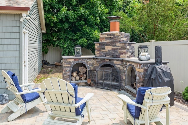 15 Orchard Rd, East Patchogue, NY 11772 - view of patio / terrace featuring an outdoor stone fireplace