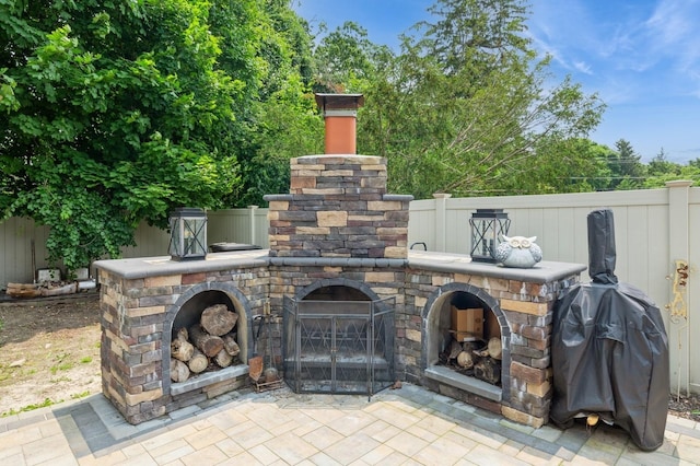 15 Orchard Rd, East Patchogue, NY 11772 - view of patio / terrace with an outdoor stone fireplace