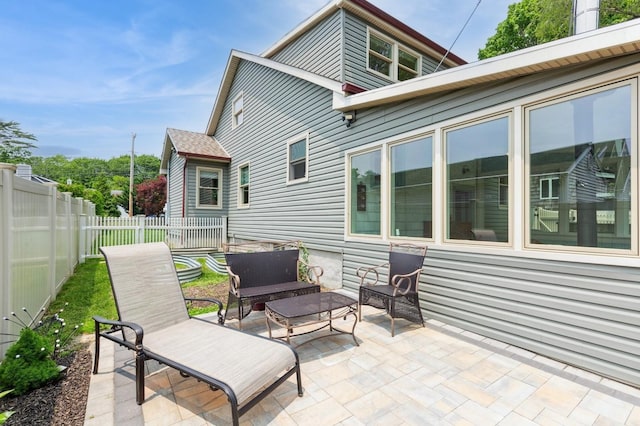 15 Orchard Rd, East Patchogue, NY 11772 - fenced backyard with a patio area