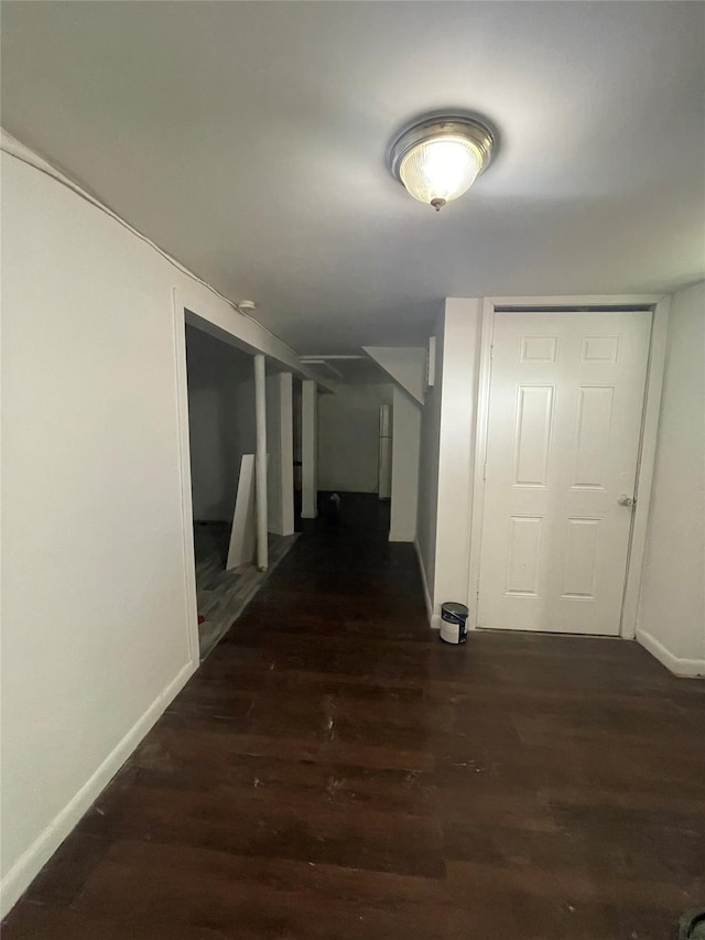 10 Kirby Ln, Central Islip, NY 11722 - hallway with baseboards and dark wood-style floors