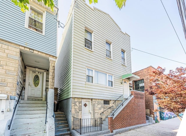 5883 57th Rd, Maspeth, NY 11378 - view of front of property featuring stone siding, entry steps, and stairway
