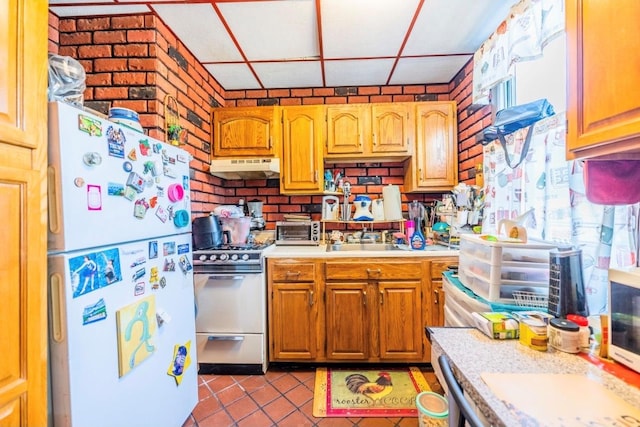 5883 57th Rd, Maspeth, NY 11378 - kitchen with white appliances, under cabinet range hood, light countertops, tile patterned flooring, and brown cabinetry