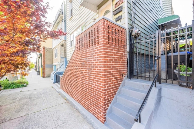 5883 57th Rd, Maspeth, NY 11378 - view of side of home featuring entry steps and brick siding