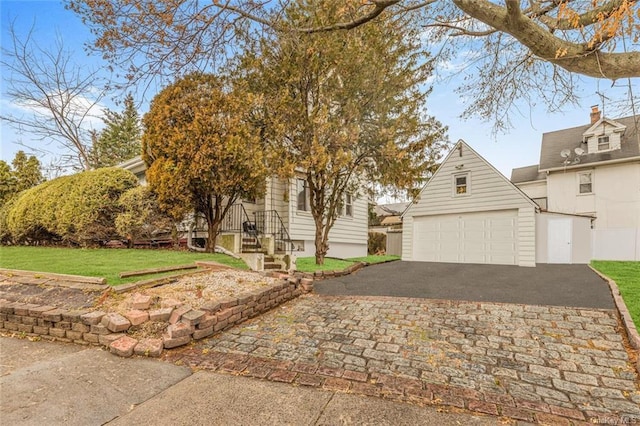 21 Clinton St, Port Chester, NY 10573 - view of front of house with an outdoor structure, a garage, asphalt driveway, and a front lawn