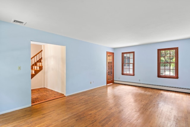 206 Lower Sheep Pasture Rd, Setauket, NY 11733 - unfurnished room with hardwood / wood-style flooring, stairway, and a baseboard heating unit