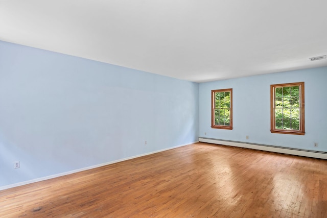 206 Lower Sheep Pasture Rd, Setauket, NY 11733 - empty room with light wood-style flooring and a baseboard heating unit
