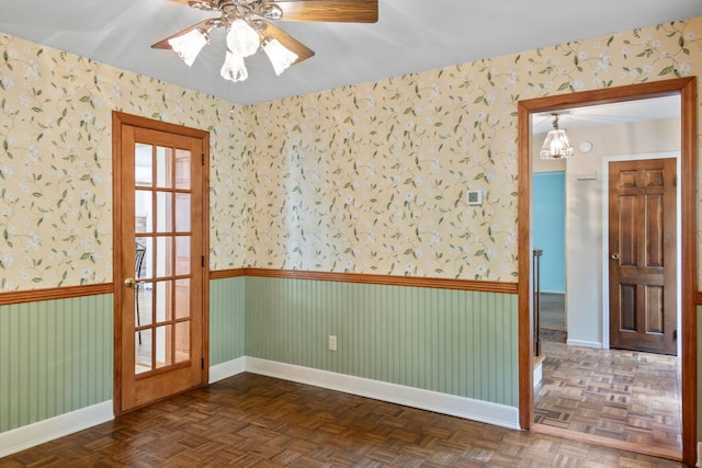 206 Lower Sheep Pasture Rd, Setauket, NY 11733 - unfurnished room with wallpapered walls, ceiling fan, wainscoting, and a chandelier