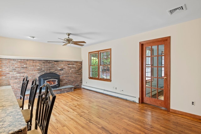 206 Lower Sheep Pasture Rd, Setauket, NY 11733 - unfurnished living room featuring a baseboard radiator, wood finished floors, and ceiling fan