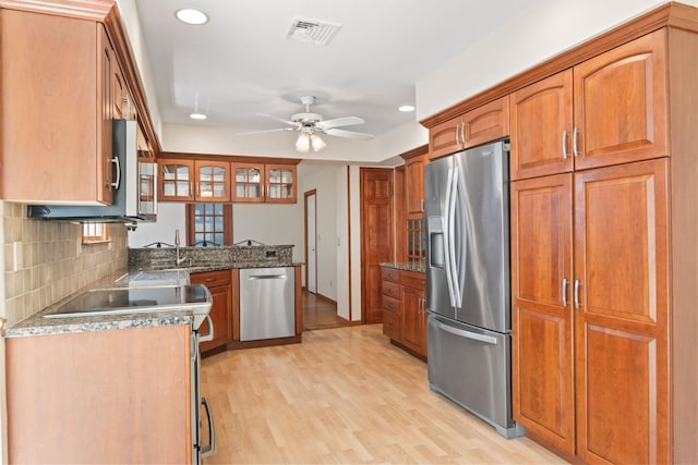 206 Lower Sheep Pasture Rd, Setauket, NY 11733 - kitchen featuring stainless steel appliances, light wood-type flooring, ceiling fan, brown cabinets, and recessed lighting