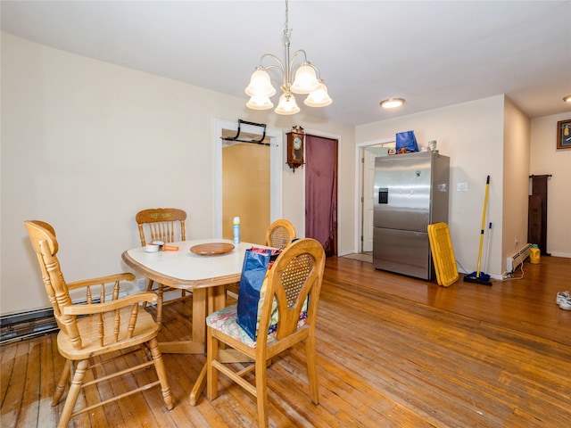 413 Vassar Rd, Poughkeepsie, NY 12603 - dining space with a chandelier, a baseboard heating unit, light wood-style floors, and baseboards