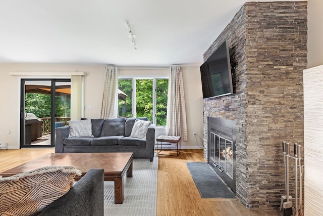 59 Krystal Dr, Somers, NY 10589 - living room with plenty of natural light, a stone fireplace, and light wood finished floors