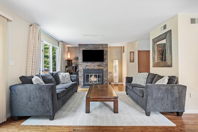 59 Krystal Dr, Somers, NY 10589 - living room featuring light wood-style flooring, rail lighting, and a fireplace