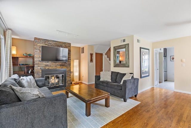 59 Krystal Dr, Somers, NY 10589 - living area featuring track lighting, stairs, a fireplace, and light wood-style floors