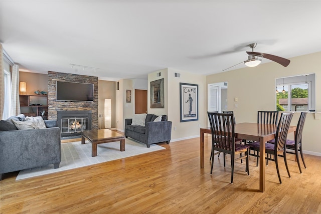 59 Krystal Dr, Somers, NY 10589 - dining area with light wood-style flooring, ceiling fan, a fireplace, and track lighting