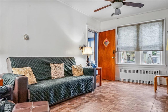 10712 Sutter Ave, Ozone Park, NY 11417 - living area featuring radiator heating unit, ceiling fan, ornamental molding, and brick patterned floors