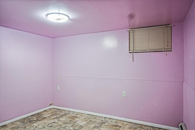 10712 Sutter Ave, Ozone Park, NY 11417 - unfurnished room featuring a baseboard radiator and baseboards