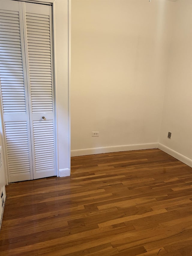 43-25 Douglaston Pkwy Unit 2D, Douglaston, NY 11363 - unfurnished bedroom featuring a closet and dark wood finished floors