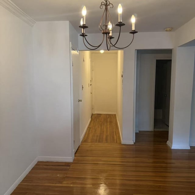 43-25 Douglaston Pkwy Unit 2D, Douglaston, NY 11363 - unfurnished dining area with a chandelier and wood finished floors