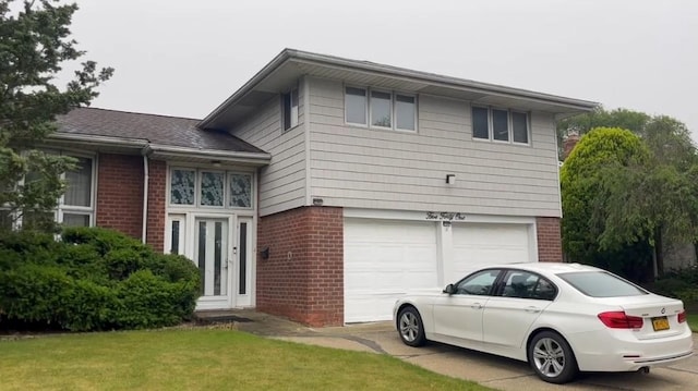 541 Woodbury Rd, Plainview, NY 11803 - view of front of property featuring brick siding, an attached garage, and concrete driveway