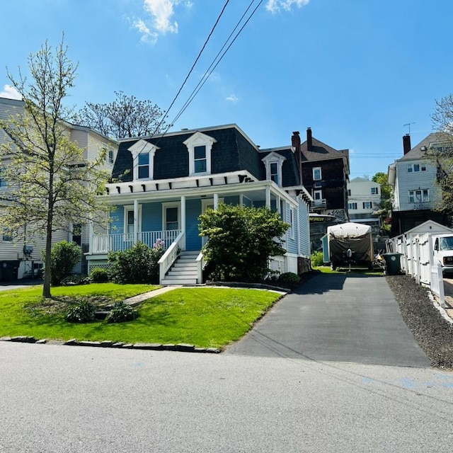 22 Spring St, Port Chester, NY 10573 - victorian home featuring mansard roof, a porch, a front yard, and driveway