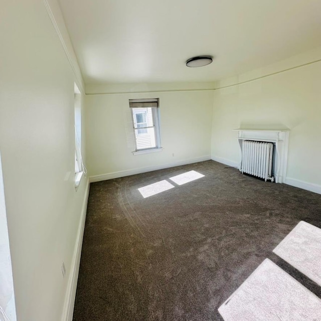 22 Spring St, Port Chester, NY 10573 - carpeted empty room with radiator and baseboards