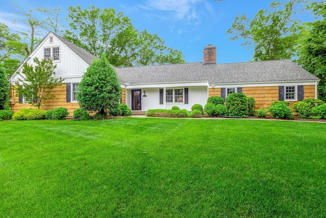 2 The Spout, Smithtown, NY 11787 - view of front of house featuring a chimney, a front yard, and a shingled roof