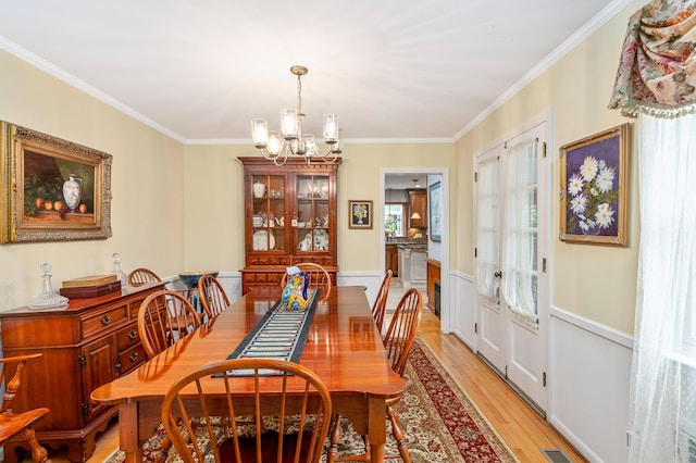 2 The Spout, Smithtown, NY 11787 - dining space with a chandelier, crown molding, and light wood-type flooring