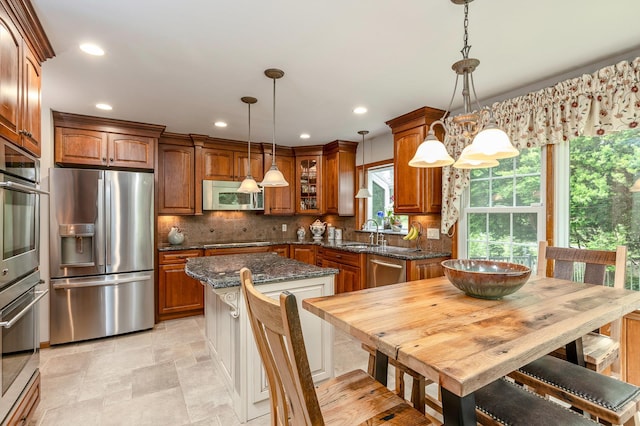 2 The Spout, Smithtown, NY 11787 - kitchen with stainless steel appliances, brown cabinets, a center island, glass insert cabinets, and recessed lighting