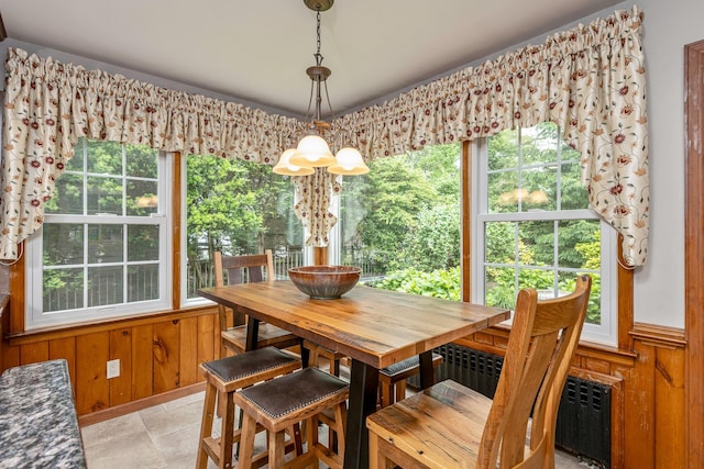 2 The Spout, Smithtown, NY 11787 - dining area featuring wood walls, healthy amount of natural light, light stone finish flooring, and wainscoting