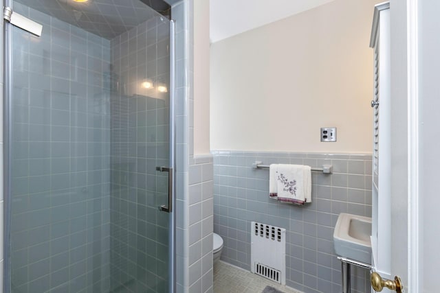 2 The Spout, Smithtown, NY 11787 - bathroom with radiator, a shower stall, tile walls, and a wainscoted wall