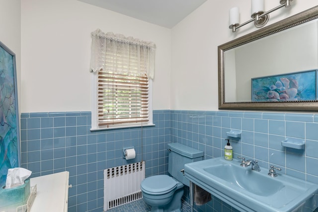 2 The Spout, Smithtown, NY 11787 - bathroom with radiator heating unit, tile walls, a wainscoted wall, and tile patterned flooring